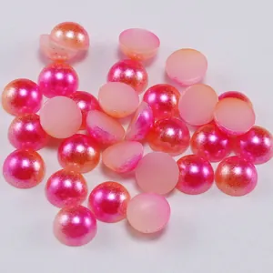 Macro shot of pink gradient flatback resin pearls with shimmering pearlized finish