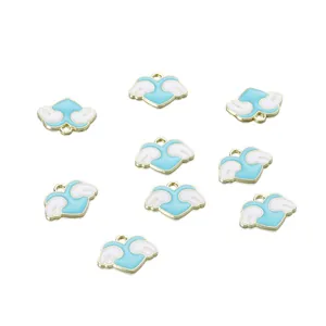Detailed view of nine sky blue heart-shaped wing charms with gold alloy edges