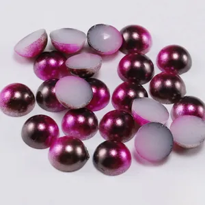 Macro detail of metallic purple gradient semi-round flatback pearls for DIY crafts