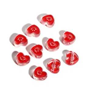 Macro detail of acrylic heart beads with smile pattern for DIY jewelry making