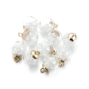 Macro detail of 10 clear glass star pendants with gold metal loops for DIY jewelry