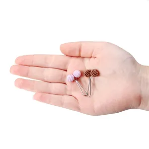 Pastel color plastic steel needle scarf clips with textured double beads shown in hand