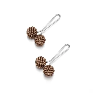 Detail of dark brown beaded pins with silver metal base for scarves and cardigans