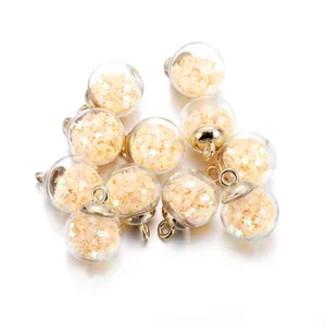 Macro detail of 10 clear glass star pendants with gold metal caps for DIY jewelry