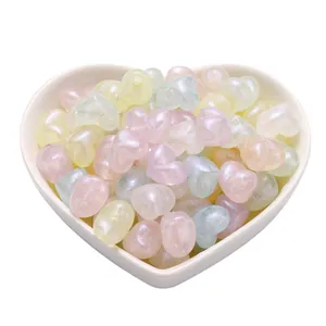 Pastel heart beads with pearlescent finish in a white heart shaped ceramic bowl