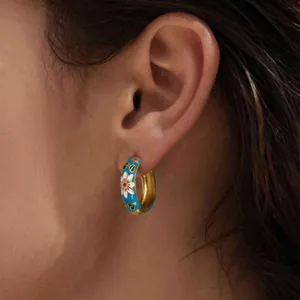 Blue enamel hoop earrings with white daisy floral patterns in 18k gold plated finish