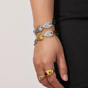 Golden heart necklace and leaf chain bracelet set with red gemstone ring in minimalist style