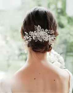Detailed back view of a silver flower hair comb with rhinestones and faux pearls
