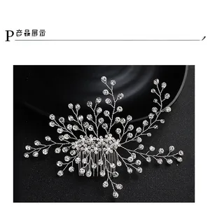 Macro detail of bridal hair comb with silver wire branches, rhinestones and pearls