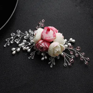 Detail of handmade bridal hair comb with fabric roses, faux pearls and crystals