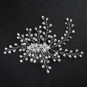 Silver bridal hair comb with pearls and rhinestones on a black background