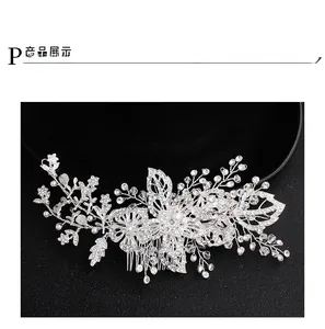 Detail view of bridal hair comb with crystal flowers and white pearls on silver wire