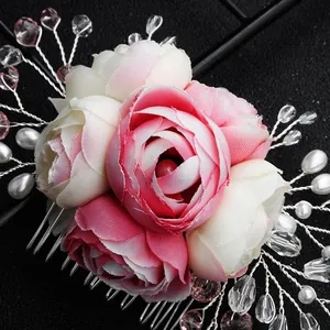 Detailed view of handmade pink roses bridal hair comb with crystals and white pearls