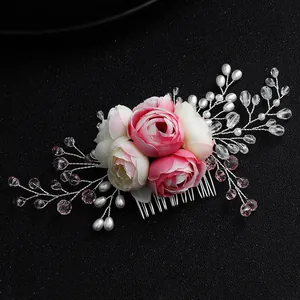 Elegant bridal hair comb with pink silk roses, pearls, and crystals on a dark background