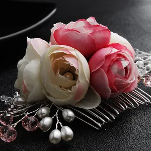 Elegant bridal hair comb with handmade flowers, pearls, and crystals on a dark background