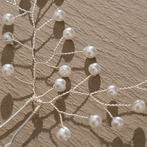 Handmade silver bridal hair pin with woven pearls and tree branch design for weddings