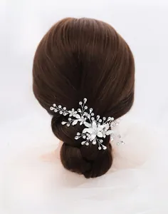 Close-up of handmade rhinestone flower hair clip on woman's hair in elegant style