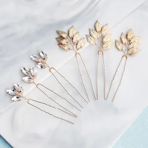 Set de 6 horquillas para el pelo con hojas doradas y diamantes sobre mármol