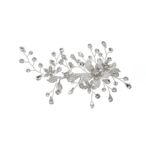 Silver floral bridal hair clip with intricate metal flowers and sparkling rhinestones