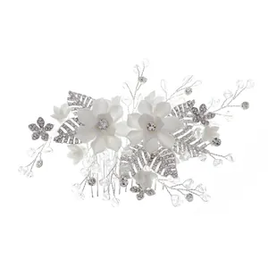 Elegant bridal hair comb with handmade white flowers, crystals, and silver leaves decor