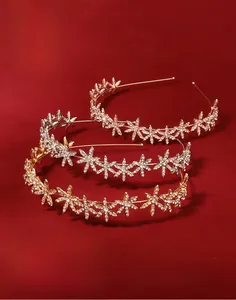 Detailed view of silver and gold star-shaped rhinestone headbands on red background