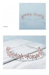 Macro detail of rose gold floral headband with white crystals on marble background