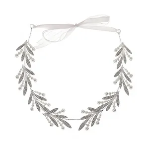 Detail of silver bridal headband with crystal leaves, pearls and white ribbon