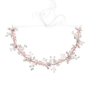 Close-up of handmade bridal hair vine with pink crystals, white pearls and silk ribbons