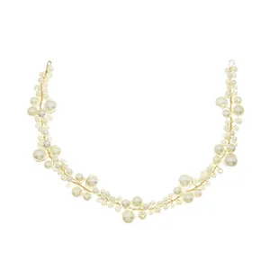 Detail of handcrafted bridal headband with cluster of white pearls on gold wire