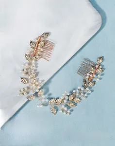 Detail of handcrafted gold leaves and white pearls on bridal hair combs for wedding styling