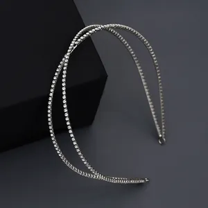 Sparkling double-layered bridal headband with intertwined rhinestone bands on black display