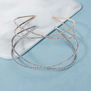 Elegant bridal rhinestone cross headband in gold and silver finish for weddings