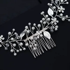 Silver bridal hair comb with pearls and crystals on a professional black background