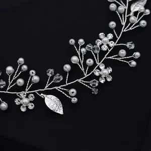 Elegant bridal hair vine with silver wire, white pearls and crystal leaves on black background