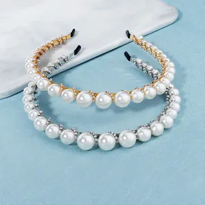 Elegant pearl and rhinestone headband available in gold and silver finishes