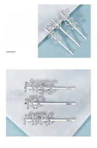 Close-up of three silver-toned hair pins with MISS, TO, and MRS rhinestone lettering