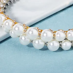 Elegant double row pearl headband with sparkling rhinestone accents on a gold base