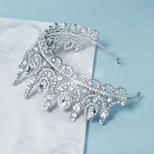 Elegant silver bridal crown with teardrop rhinestones on white marble background