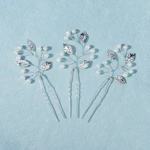 Three-piece silver bridal hair pins set featuring pearl accents and metallic leaf designs