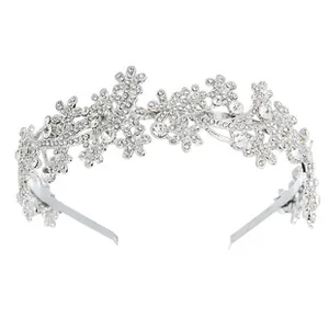 Detailed close-up of a silver bridal headpiece with crystal flowers and vine designs