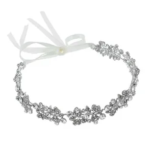 Detailed close-up of bridal crystal leaf headband with white satin ribbon ties