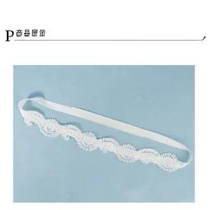 Close-up of elegant white floral lace headband with satin ribbon ties for bridal wear