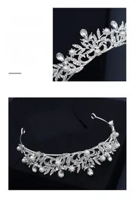 Detailed close-up of intricate silver tiara with white pearls and sparkling rhinestones