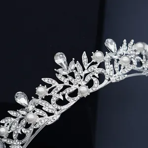Elegant silver alloy bridal crown with sparkling rhinestones and white pearls on black background