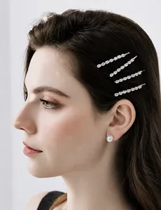 Macro detail of silver metal hair clips with sparkling zircons worn by a female model