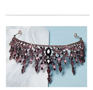 Detail of vintage Baroque tiara with purple rhinestones and hanging crystal pendants
