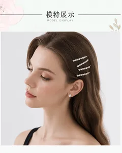Detail shot of four silver rhinestone hair clips styled on a model with pearl earring