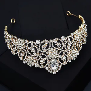 Luxurious gold baroque bridal tiara featuring intricate crystals and an oval center gem