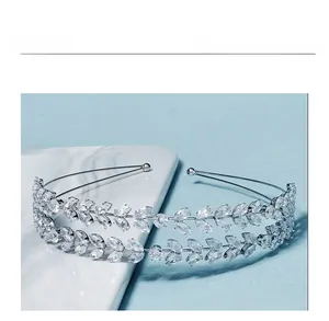 Close-up of double-layered silver headband with marquise zircon leaves on marble