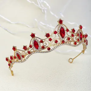 Macro detail of golden bridal tiara with red marquise gems and white rhinestones